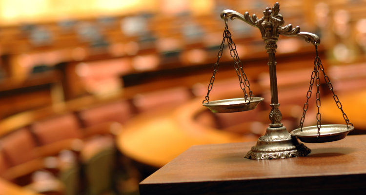 Scales of Justice sit on a desk in a courtroom