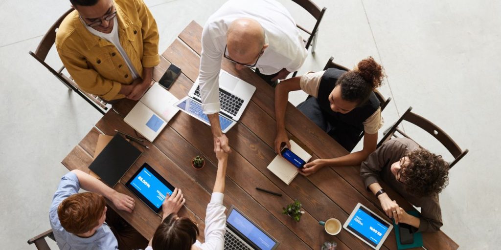 A group of professionals talk about entity formation options during a business meeting.