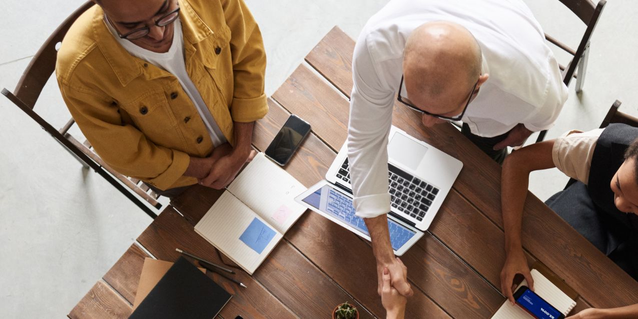 Two LLC members discuss business operations with their lawyer.