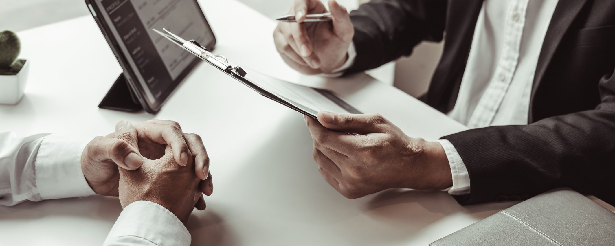 Lawyer with clipboard discussing a client's business goals