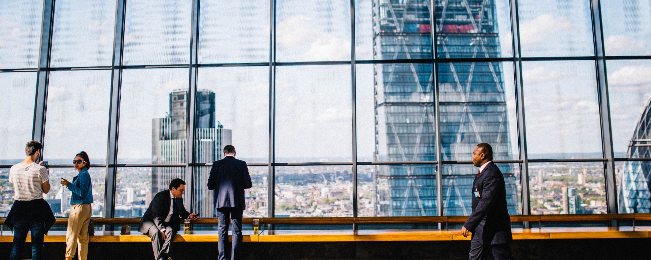 Business professionals walk down a city street.
