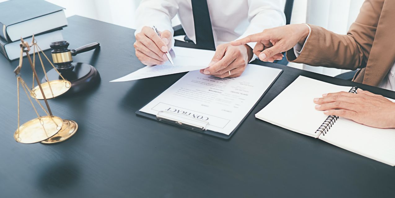Lawyer goes through paperwork with a pen on the desk