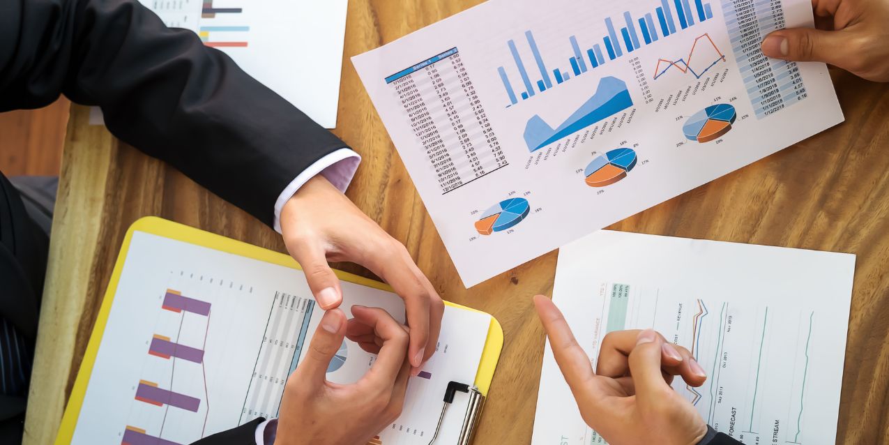 A client and attorney sort through business paperwork and other information for entity selection.