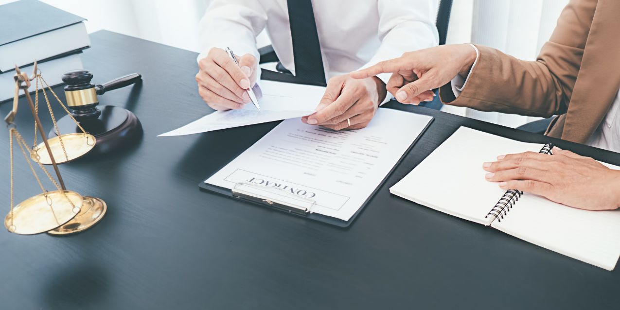 Business partners review paperwork with their attorney