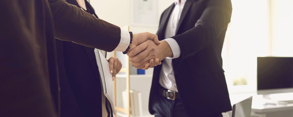 Two business partners shake hands.