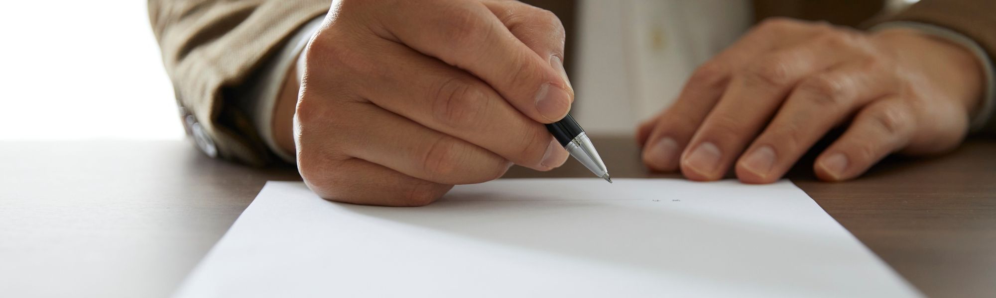 A man signs a business contract.